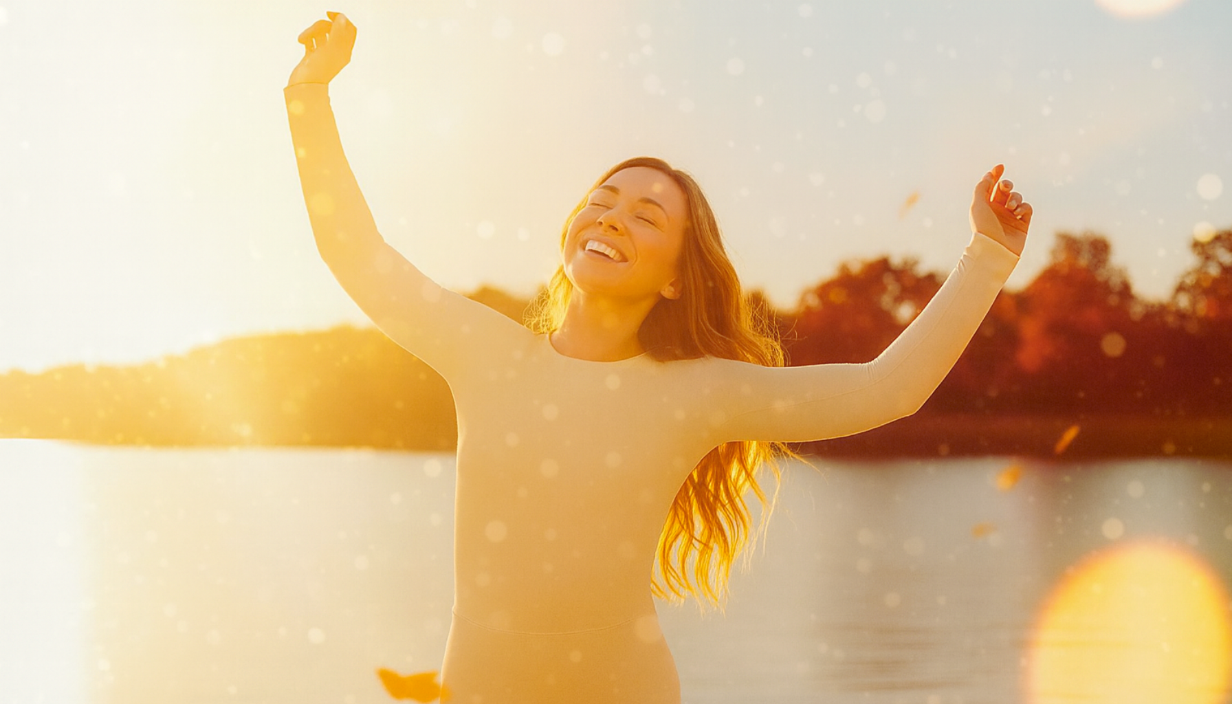 Person mit erhobenen Armen und geschlossenen Augen im Sonnenlicht – Moment der Vitalität, innerer Ruhe und regenerierter Zellkraft.